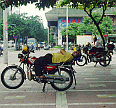 Image: The Art of Chinese Motorcycle Zen, as practiced by a Motorcycle Taxi. Complete with Rider Taking-5. This Machine Appears to Feature the Latest in Ergonomic Design